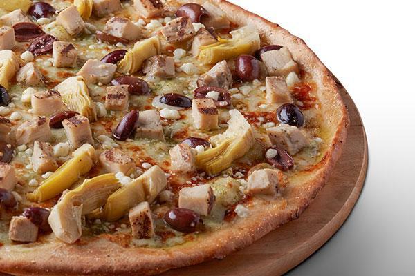 Creamy Pesto Chicken · Creamy Pesto Garlic Sauce on our Tuscany Thin Crust, topped with Mozzarella Cheese, All-Natural Grilled Chicken, Green Olives, Marinated Artichoke Hearts, and Feta Cheese.