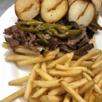 Steak and Hot Peppers Sandwich · Thinly sliced rib eye, sauteed long hot Italian peppers, with fried sliced potatoes on a lon...
