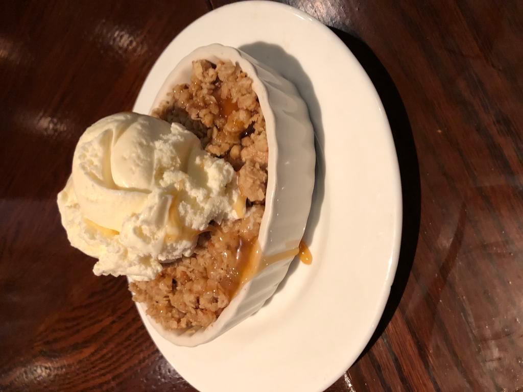 Homemade Apple Crisp · Granny Smith apples seasoned with cinnamon 
and sugar then sprinkled with buttery crumb 
topping served warm with vanilla bean 
