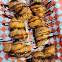 Cinnamon Knots · Fried dough knots covered in cinnamon and sugar. Topped with caramel and chocolate sauce.