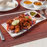 Chicken Pakora · Boneless tender pieces of chicken, dipped in chickpea batter and deep-fried. Served with chu...