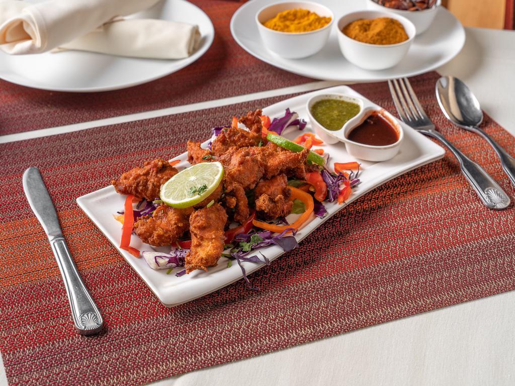 Chicken Pakora · Boneless tender pieces of chicken, dipped in chickpea batter and deep-fried. Served with chutney.