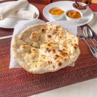 Naan · Leavened white flour bread baked in our tandoor.