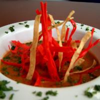 Sopa de Tortilla · Signature tortilla soup with grilled chicken and fried tortilla hay.
