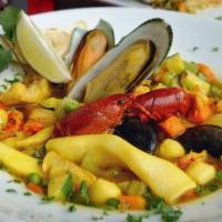Paella · Seafood, chicken, pork, sausage and vegetables mingled in fluffy saffron rice.