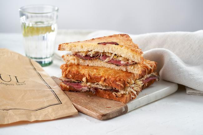 Croque Reuben · Peppered beef pastrami, Ssuerkraut, mustard, and melted swiss cheese between two crispy slices of bread topped with butter. Served with a side salad.