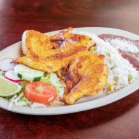 Pollo ala Plancha  · Grilled chicken breast served with rice, beans fresh salad and hand made tortilla.