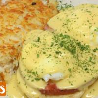 Eggs Benedict · Toasted English muffin topped with ham, poached eggs, and Hollandaise sauce served with choi...