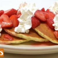 Strawberry Pancakes · Topped with fresh strawberries, powdered sugar and whipped cream.