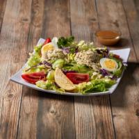 Tuna Salad · White meat albacore tuna salad with tomato wedges and a hard-boiled egg served on a bed of i...
