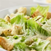 Caesar Salad · Crisp romaine tossed with shredded Parmesan cheese & dressing. Topped with seasoned croutons.