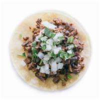 Steak Taco · Topped with diced onion and cilantro. Choice of corn or flour tortilla.