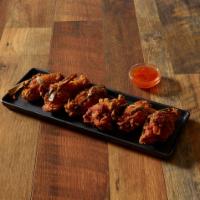 Crispy Chicken Wings · 6 pieces. Deep fried marinated chicken wings wrapped in pine leaves with sweet chili sauce o...
