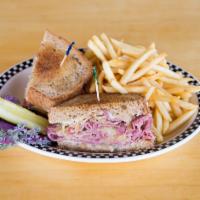 Grilled Reuben Sandwich · Shaved corned beef, grilled and piled high with sauerkraut, Dijon mustard, smothered with Sw...