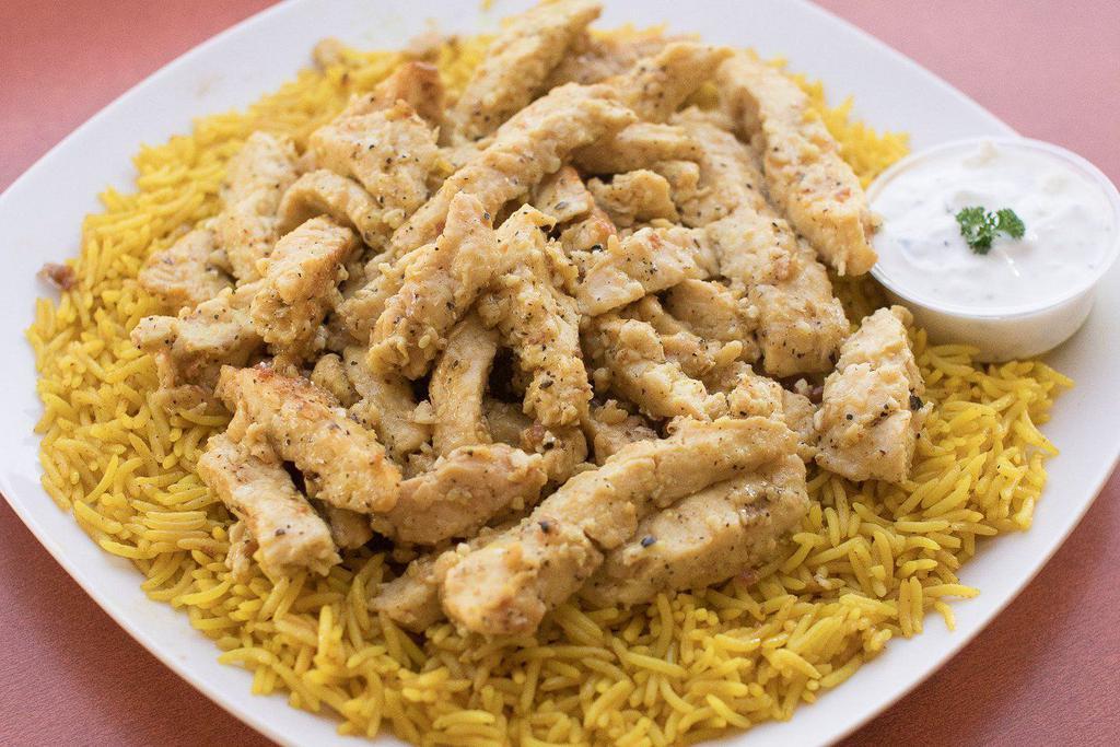 Chicken Shawarma Platter · Sliced chicken breast sauteed in shawarma spices (not spicy). Served over a bed of rice, pick a side and sauce to complete the meal.