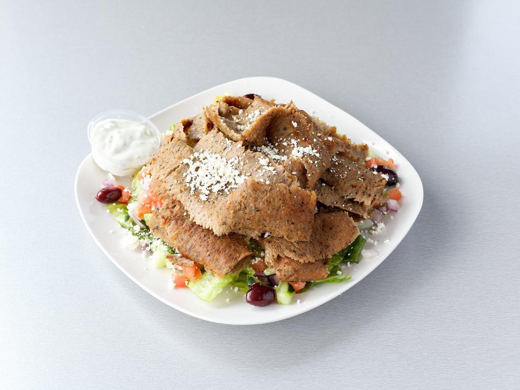 Lamb Gyro Salad · Hand shaved gyro meat served over a Greek salad with tzatziki sauce, feta, black olives, and house vinaigrette.