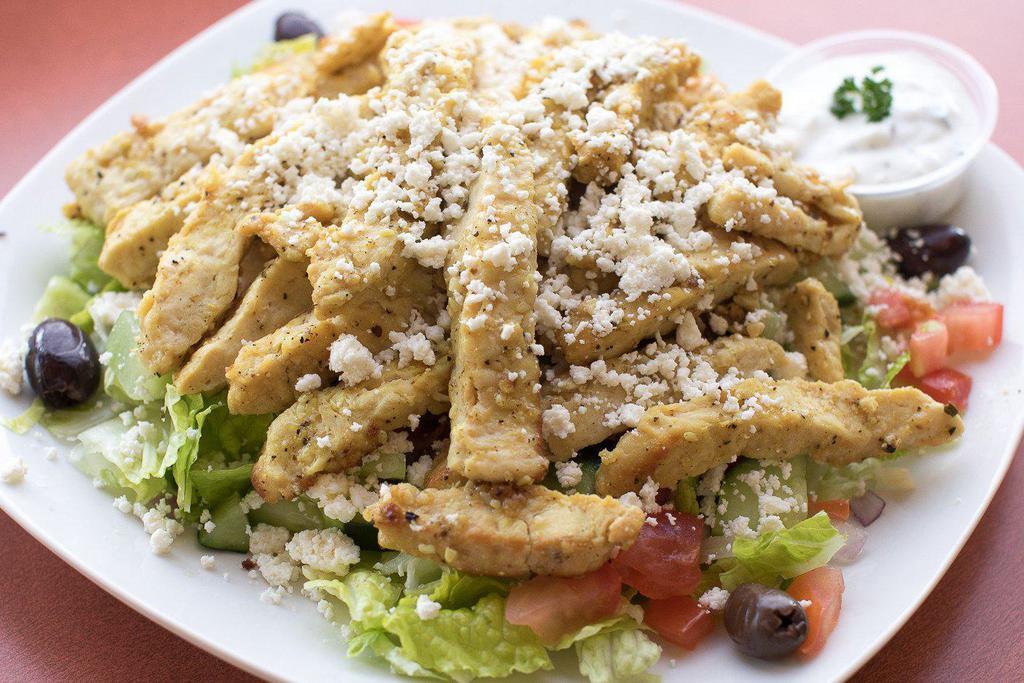 Chicken Shawarma Salad · Chicken breast slices sautéed in our special shawarma spices. Served over a Greek salad and comes with a side of tzatziki sauce.