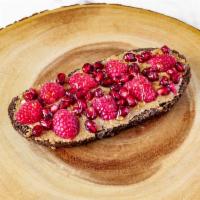 Almond Buttter Toast · Almond butter whole grain toast with raspberries, pomegranate, drizzle of raw Bulgarian honey.