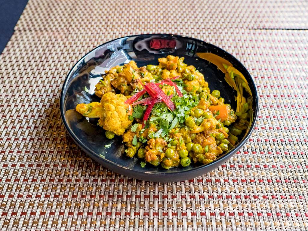 Aloo Gobi · Potatoes and cauliflower florets cooked in ginger, onion, tomato and a blend of Indian spices.