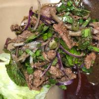 Nam Tok Salad ยำน้ำตก · Pork or beef. A spicy and sour salad of grill pork or beef, onions, lime juice,  fish sauce,...