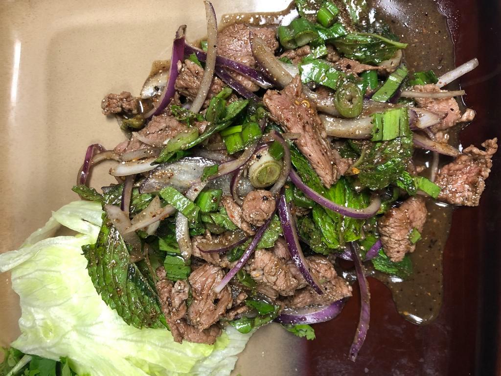 Nam Tok Salad ยำน้ำตก · Pork or beef. A spicy and sour salad of grill pork or beef, onions, lime juice,  fish sauce, chili, ground roasted rice and min Spicy.