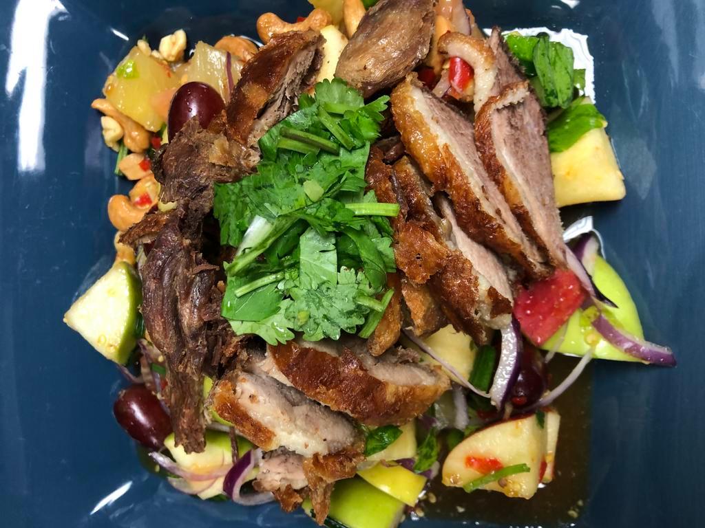 Crispy Duck Salad ยำเป็ดกรอบ · Crispy 1/2 fried duck with apple, pineapple, onion, peanut, cashew nut, scallion, chili in homemade spicy and sour sauce. Spicy.