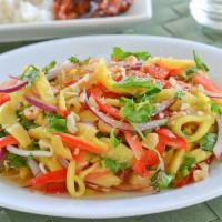 Mango Salad · Tangy mango, red onion, scallion, cilantro and peanuts in sweet and sour dressing. 