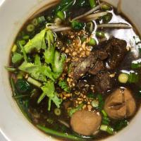 Braised Beef Noodle Soup ก๋วยเตี๋ยวเนื้อตุ๋น · Rice noodle with slow cooked beef and beef ball in dark soup.