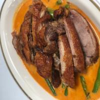 Duck Panang เป็ดพะเเนง · Crispy 1/2 duck with basil in coconut milk and Panang curry paste. Spicy.