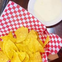 Tortilla Chips and Queso · Fresh tortilla chips and homemade white queso dip.