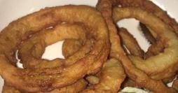 Onion Rings · Beer battered, tasty and delicious. Served with our house-made secret sauce.