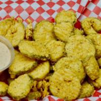 Fried Pickles · Pickle chips tossed in our homemade batter and fried crispy. Served with a side of ranch.