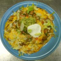 Mexican Pizza · A crisp flour tortilla topped with refried beans, your choice of chicken or ground beef, and...