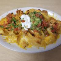 Super Nachos · Crispy corn tortilla chips topped with refried beans your choice of meat, melted cheese garn...