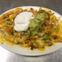 Steak and Fries · A bed of golden fries, carne asada meat, melted cheese, garnished with guacamole and sour cr...