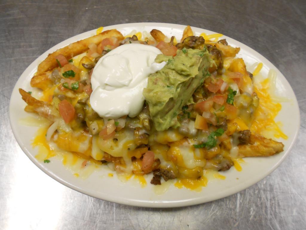 Steak and Fries · A bed of golden fries, carne asada meat, melted cheese, garnished with guacamole and sour cream.