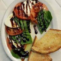 Caprese Salad · Sliced tomatoes, fresh mozzarella and basil, drizzled with olive oil and balsamic glaze.