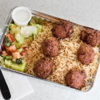 Falafel over Rice · Served over brown basmati rice with choice of salad and Shah's sauces.