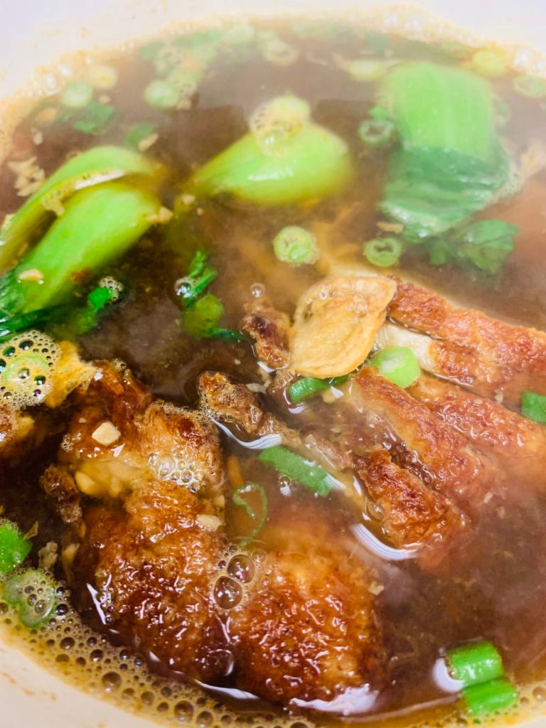 2. Duck Noodle Soup · A bowl of soup with thin rice noodles served with Asian assorted vegetables.