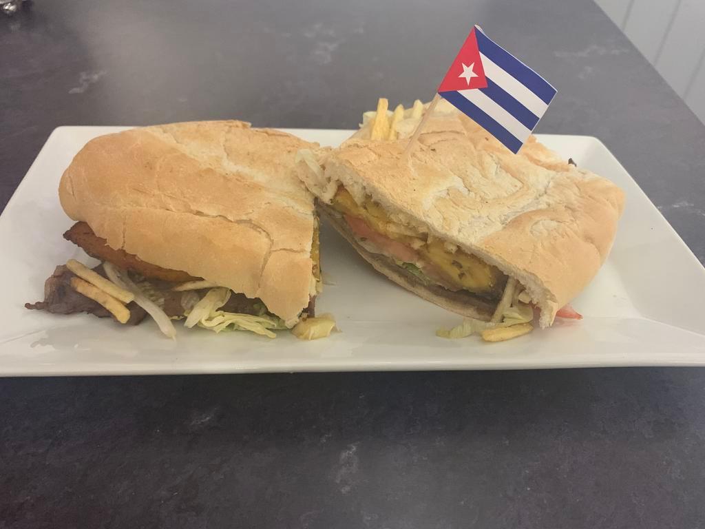 Pan con Bistec Sandwich · Steak sandwich made with sauteed onion, lettuce, tomato, mayonnaise, and shredded potato sticks on Cuban bread.