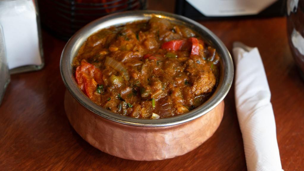Shrimp Bhuna · Boneless meat pieces cooked with onion, tomatoes, bell peppers and spices. **Onions cannot be removed.