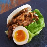 Bun · Steamed bun with onions, tomatoes and lettuce.