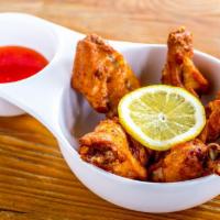 Thai Style Fried Chicken Wings · Served with house spicy, sweet and sour sauce.