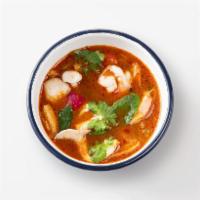 Tom Yum Goong · Thai spicy soup with Tiger prawns, Shimeji mushrooms and aromatic Thai herbs.