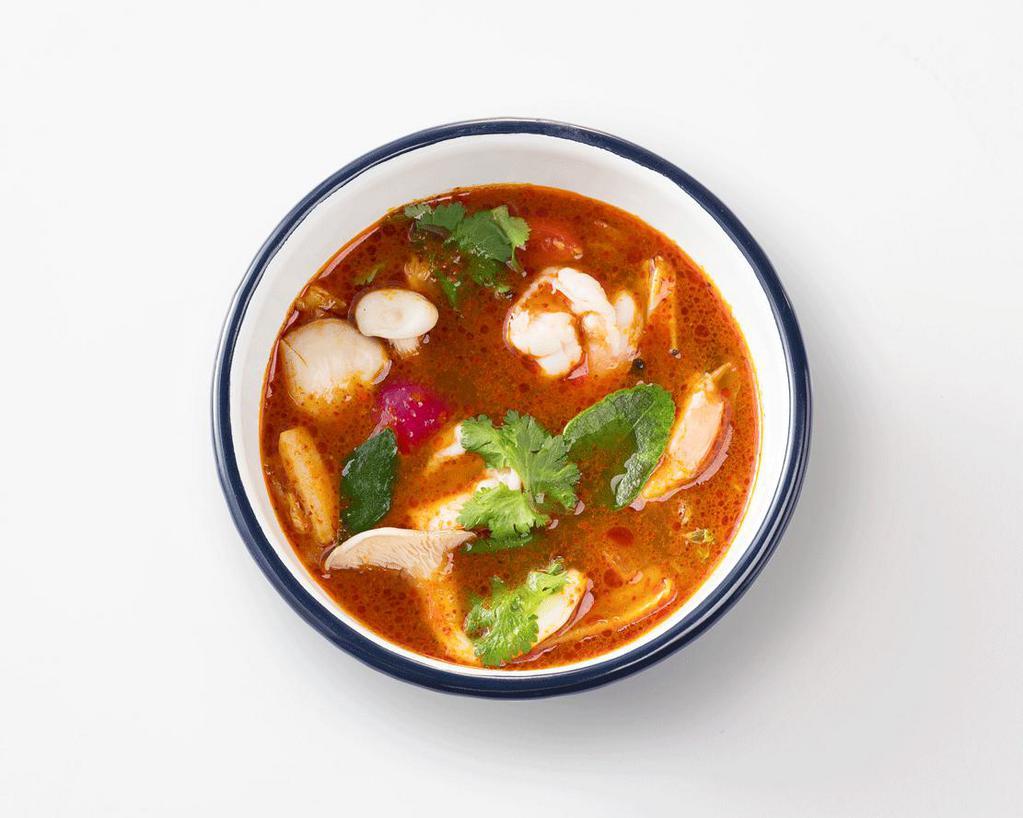 Tom Yum Goong · Thai spicy soup with Tiger prawns, Shimeji mushrooms and aromatic Thai herbs.