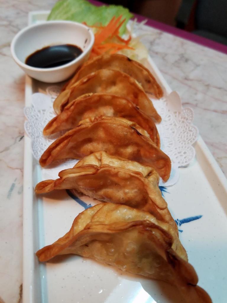 A3. Potsticker · Deep Fried Potsticker filled with chicken and vegetable. Served with sweet sour sauce.