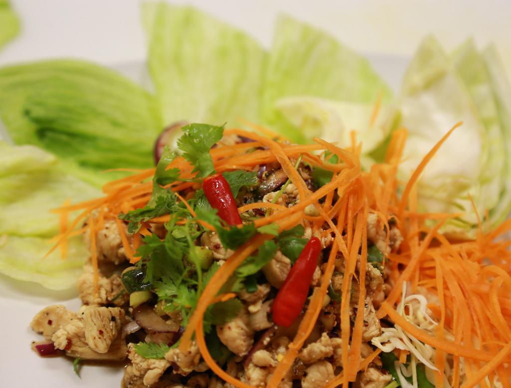 SL1.   Larb Salads · Served with your choice of ground chicken or beef with red onions, green onions, roasted rice powder and with a lime juice fish sauce dressing served on a bed of lettuce. Spicy.