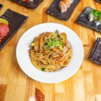 Chicken Yaki Udon · Pan-fried udon noodles with zucchini, carrots, and broccoli, and chicken, topped with green ...