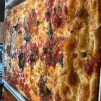Grandma Sicilian Pizza · Grandma Sicilian pizza  layered with mozzarella and our own Italian plum tomato sauce.
