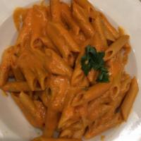 Penne alla Vodka - Large Order · Penne pasta sautéed with shallots, touch of tomatoes in a pink vodka cream sauce. Pasta serv...
